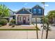 Beautiful two-story home featuring a red brick facade, blue siding, and a well-manicured lawn at 23451 S 228Th St, Queen Creek, AZ 85142