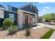 Stylish two-story home with a brick accent wall, neat landscaping, and a cozy front porch at 23451 S 228Th St, Queen Creek, AZ 85142