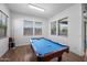 Bright game room featuring a well-lit pool table and multiple windows at 223451 S 228Th St, Queen Creek, AZ 85142