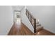 Clean hallway with hardwood floors leading to a staircase and a view of the backyard at 23451 S 228Th St, Queen Creek, AZ 85142
