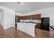 Spacious kitchen with stainless steel appliances, a large island, and hardwood floors at 23451 S 228Th St, Queen Creek, AZ 85142
