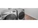 Laundry room featuring Samsung washer and dryer with wood-look vinyl flooring at 23451 S 228Th St, Queen Creek, AZ 85142