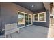 Covered patio with white metal bench, sliding glass door, and view of backyard at 23451 S 228Th St, Queen Creek, AZ 85142