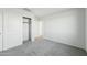 Bright bedroom with closet, neutral carpet, and modern white walls for a clean, minimalist aesthetic at 22387 S Manzanilla Rd, Buckeye, AZ 85326