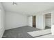 Spacious bedroom features plush carpet, an abundance of natural light, and en-suite bathroom at 22387 S Manzanilla Rd, Buckeye, AZ 85326