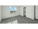 Bright bedroom with plush carpet, a sliding-door closet, and a large window at 22387 S Manzanilla Rd, Buckeye, AZ 85326