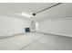 Spacious garage with a sealed concrete floor, white walls, and an installed water heater at 22387 S Manzanilla Rd, Buckeye, AZ 85326