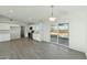 Bright open kitchen with stainless steel appliances, white cabinetry, and a sliding glass door at 22387 S Manzanilla Rd, Buckeye, AZ 85326