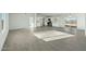 Open-concept living room with kitchen access and sliding glass door at 22387 S Manzanilla Rd, Buckeye, AZ 85326