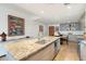 Open kitchen with granite countertops and modern appliances, with an eating bar and dining area at 2300 E Campbell Ave # 104, Phoenix, AZ 85016