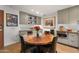 A modern dining area features a round wooden table with seating and built-in shelving at 2300 E Campbell Ave # 104, Phoenix, AZ 85016