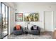A sunlit seating area has two leather chairs and a sliding glass door to the patio at 2300 E Campbell Ave # 104, Phoenix, AZ 85016