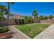 Backyard featuring a lawn with pavers, greenery, and trees under a clear blue sky at 233 W Sweet Shrub Ave, San Tan Valley, AZ 85140