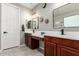 Bathroom with granite countertops, dual sinks, modern mirrors, and elegant lighting at 233 W Sweet Shrub Ave, San Tan Valley, AZ 85140