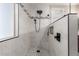 Luxurious bathroom with stylish black fixtures, elegant white subway tile, and a rainfall shower head at 233 W Sweet Shrub Ave, San Tan Valley, AZ 85140