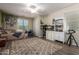 Cozy bedroom featuring a ceiling fan, large rug, and white dresser with bookshelves at 233 W Sweet Shrub Ave, San Tan Valley, AZ 85140