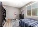 Bedroom showcasing hardwood floors, ceiling fan, and basketball hoop for a sporty, fun design at 233 W Sweet Shrub Ave, San Tan Valley, AZ 85140