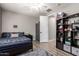 Bedroom displaying hardwood floors, ceiling fan, and organized shelving for functional decor at 233 W Sweet Shrub Ave, San Tan Valley, AZ 85140