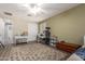 Bright bedroom showcasing hardwood floors, ceiling fan, neutral tones, and a decorative cat tree at 233 W Sweet Shrub Ave, San Tan Valley, AZ 85140