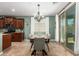 Charming dining area with stylish light fixture, window and slider to the yard at 233 W Sweet Shrub Ave, San Tan Valley, AZ 85140