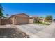 A beautiful home exterior features a well-maintained lawn and a spacious driveway at 233 W Sweet Shrub Ave, San Tan Valley, AZ 85140