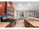 Open kitchen with granite countertops and stainless steel appliances adjacent to dining area at 233 W Sweet Shrub Ave, San Tan Valley, AZ 85140