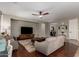 Comfortable living room with hardwood floors, a colorful rug, and modern ceiling fan at 233 W Sweet Shrub Ave, San Tan Valley, AZ 85140