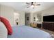 Comfortable bedroom with an en-suite bathroom, a cozy chair and lots of natural light at 233 W Sweet Shrub Ave, San Tan Valley, AZ 85140