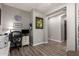 Functional home office featuring hardwood floors, a lion art piece, and a comfortable work space at 233 W Sweet Shrub Ave, San Tan Valley, AZ 85140