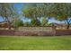 Stone sign for Ironwood Crossing community, fronted by a lush green lawn at 233 W Sweet Shrub Ave, San Tan Valley, AZ 85140