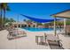 Beautiful community pool with lounge chairs, shade sails, cabana and mature landscaping for a relaxing experience at 233 W Sweet Shrub Ave, San Tan Valley, AZ 85140