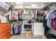 Spacious walk-in closet with organized shelving, hanging rods, and storage for clothes and accessories at 233 W Sweet Shrub Ave, San Tan Valley, AZ 85140