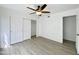 This bedroom features light woodgrain floors, a ceiling fan, and a closet with sliding doors at 2333 E Southern Ave # 1101, Tempe, AZ 85282