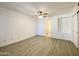 Large bedroom with light colored walls, wood-look floors, ceiling fan and window at 2333 E Southern Ave # 1101, Tempe, AZ 85282
