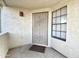 Close-up of the front door featuring security screen, exterior sconce, and window at 2333 E Southern Ave # 1101, Tempe, AZ 85282