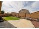 Private backyard featuring green grass, a landscaped border, and a patio, perfect for outdoor activities at 23814 W Chambers W St, Buckeye, AZ 85326