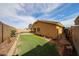 A fully fenced backyard featuring a well-maintained lawn, offering privacy and space for relaxation at 23814 W Chambers W St, Buckeye, AZ 85326
