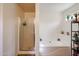 The modern bathroom includes a glass-enclosed shower and a separate soaking tub for relaxation and comfort at 23814 W Chambers W St, Buckeye, AZ 85326