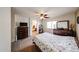 The Primary bedroom has carpet, a window, a ceiling fan, and floral bedding at 23814 W Chambers W St, Buckeye, AZ 85326