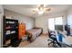 This bedroom has neutral-toned walls, a ceiling fan, a window, and carpeted floors at 23814 W Chambers W St, Buckeye, AZ 85326