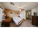 A cozy bedroom featuring floral bedding, ceiling fan, neutral color walls, and natural light at 23814 W Chambers W St, Buckeye, AZ 85326