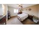 The Primary bedroom has carpet, a window, a ceiling fan, and floral bedding at 23814 W Chambers W St, Buckeye, AZ 85326