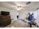 Bright bedroom with wood-look floors, a ceiling fan, and a closet with sliding doors at 23814 W Chambers W St, Buckeye, AZ 85326