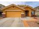 Charming single-story home with an attached two-car garage and a well-maintained desert landscape at 23814 W Chambers W St, Buckeye, AZ 85326