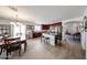 Open kitchen and dining area featuring dark cabinetry, a center island with bar seating, and modern appliances at 23814 W Chambers W St, Buckeye, AZ 85326