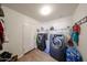 Laundry room featuring modern washer and dryer with door to the left at 23814 W Chambers W St, Buckeye, AZ 85326