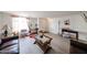 Spacious living room with light wood floors, neutral paint, a coffee table, and various decorative elements at 23814 W Chambers W St, Buckeye, AZ 85326