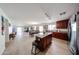 Open concept living area with stainless steel refrigerator and granite countertops at 23814 W Chambers W St, Buckeye, AZ 85326