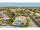 Backyard with a sparkling pool, covered patio, and lush green lawn at 2438 N Forest Cir, Mesa, AZ 85203