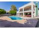 Spacious backyard with a large pool, covered patio, and views of the home's exterior at 2438 N Forest Cir, Mesa, AZ 85203